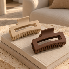 Matte beige and brown square claw clips on a linen book